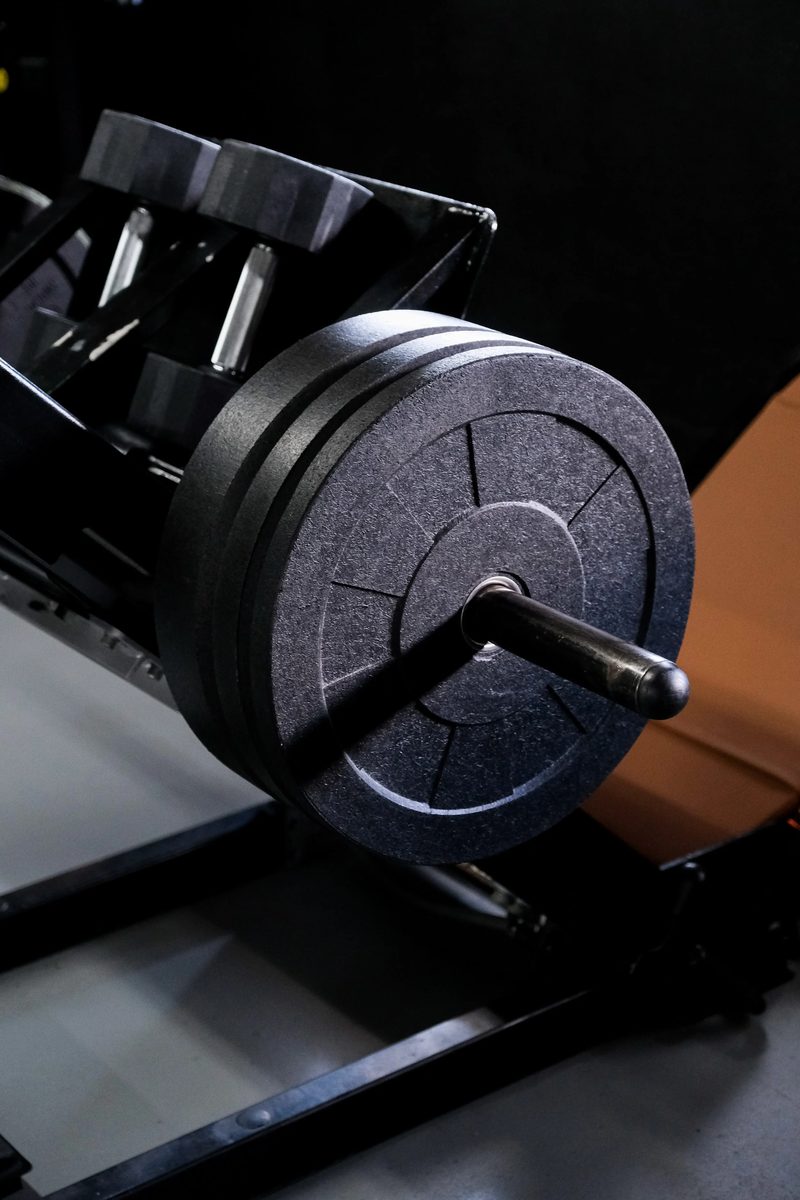 Close detail of loaded plates on a leg press